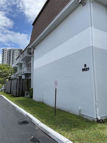 Side view of a multi-story apartment building with balconies.