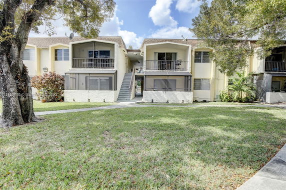 Front view of a two-story residential building with balconies.