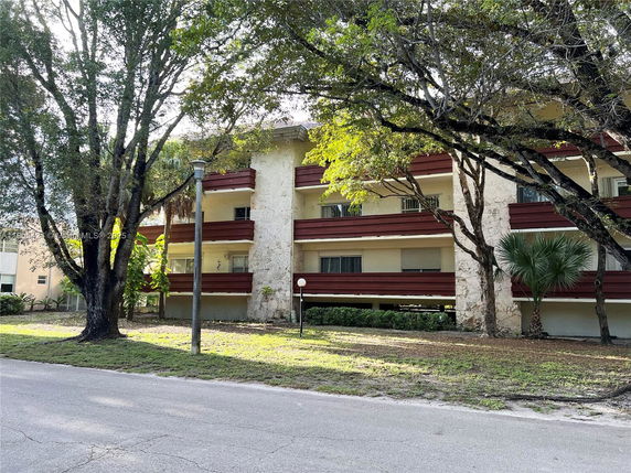 Front view of a multi-story residential building with balconies.