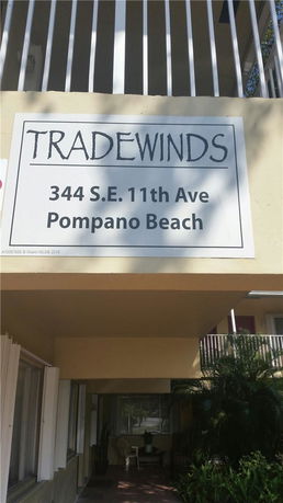 Front view of a building with a sign reading Tradewinds, 344 S.E. 11th Ave, Pompano Beach.