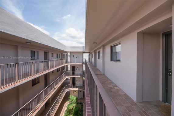 View of apartment building corridors and balconies overlooking a courtyard.