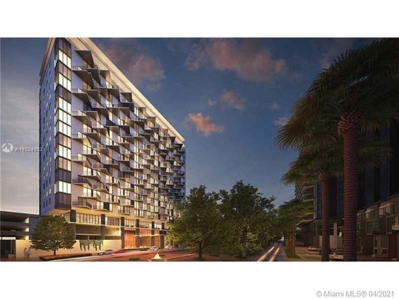 Front view of a multi-story modern building with balconies.