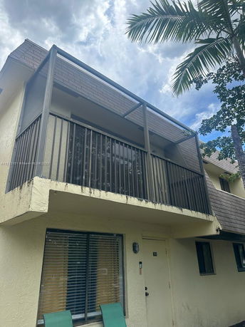 Front view of a two-story house with a balcony.
