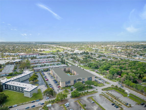 Aerial panoramic view of a residential area with several multi-story buildings and surrounding greenery.