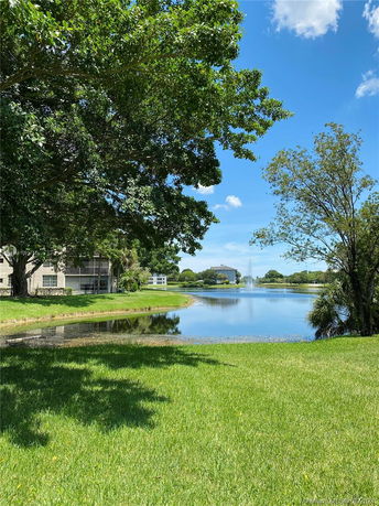 View of a lake with buildings and trees around it.