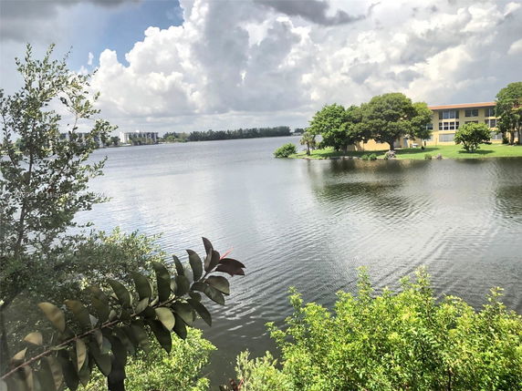 Scenic view of a lake with buildings and trees around it.