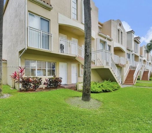 Front view of a multi-story residential building with balconies.