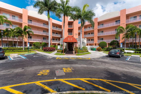 Front view of a multi-story building with a covered entrance.