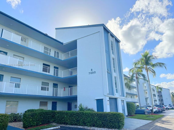 Front view of a multi-story residential building with balconies.