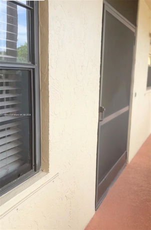 Side view of a window and a door on a building exterior.