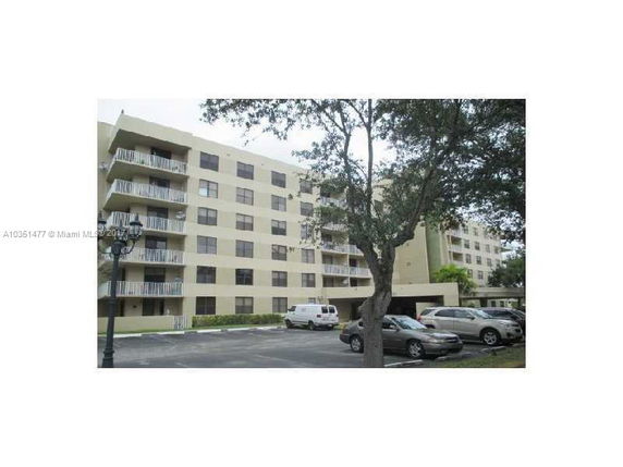 Front view of a multi-story apartment building with balconies.