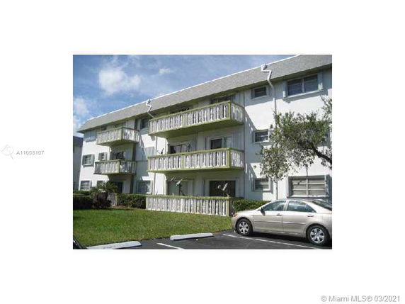 Front view of a three-story apartment building with balconies.