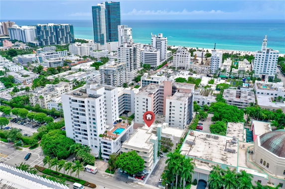 Aerial view of a coastal cityscape with high-rise buildings and the ocean in the background.