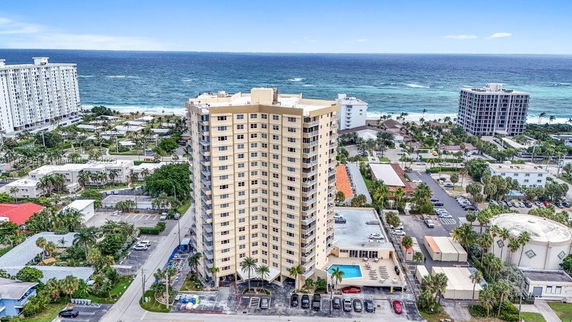 Front view of a tall residential building near the ocean.