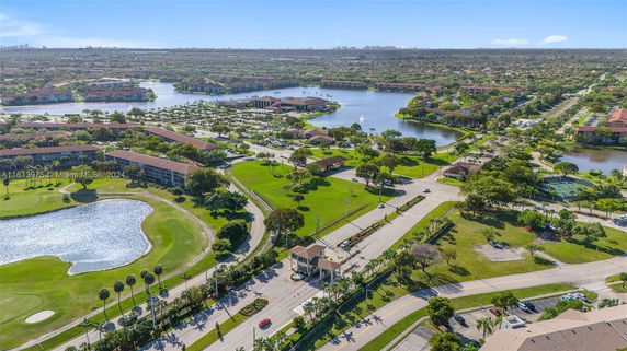 Aerial view of a residential and recreational area with lakes, roads, and buildings.