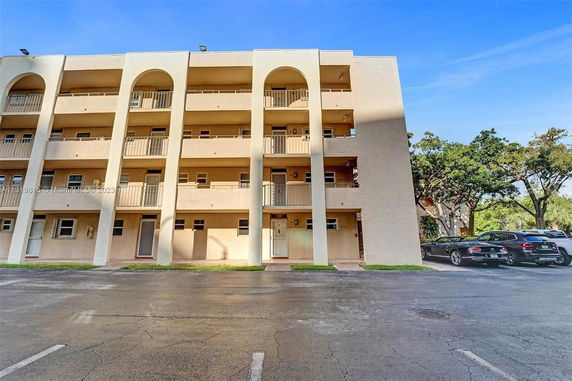 Front view of a multi-story building with balconies.