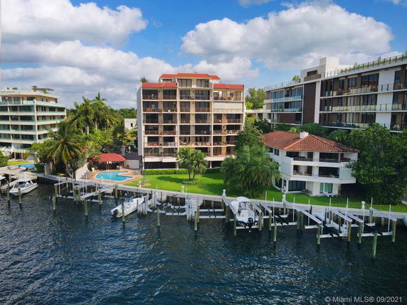 Aerial view of waterfront buildings with boat docks.