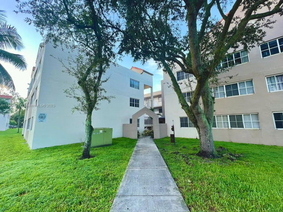 Front view of an apartment building with multiple stories.