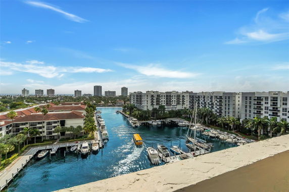 Panoramic view of waterfront buildings with boats docked along a canal.