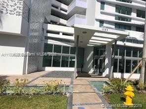 Front view of a modern multi-story building entrance.