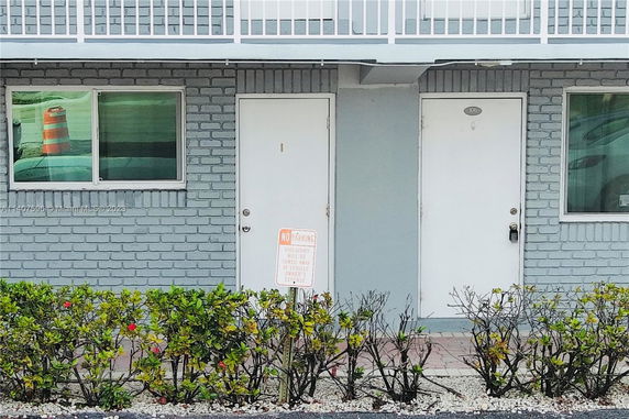Front view of a building with two doors and windows.
