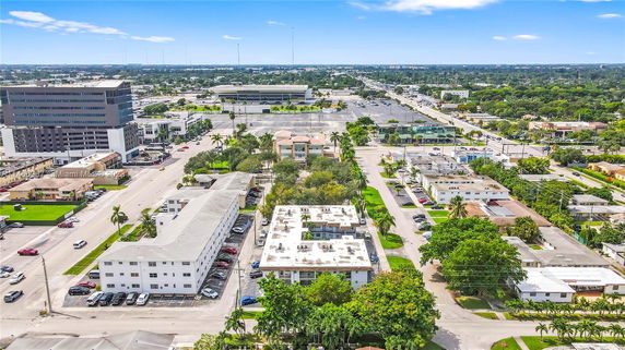 Aerial view of a city area with residential and commercial buildings.