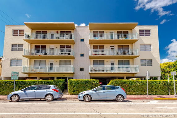 Front view of a multi-story apartment building with balconies.