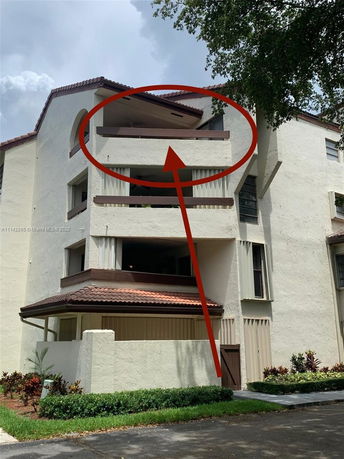 Front view of a multi-story building with multiple balconies.
