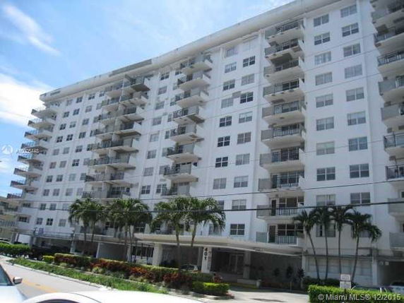 Front view of a multi-story residential building with balconies.