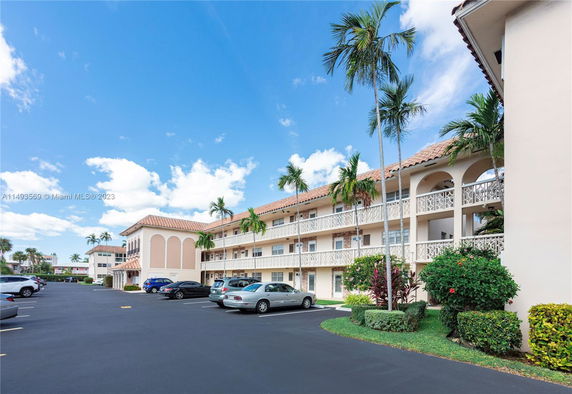Front view of a multi-story apartment building with balconies.