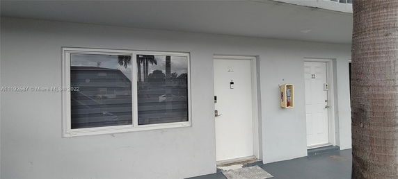 Front view of a building with adjacent doors numbered 21 and 22