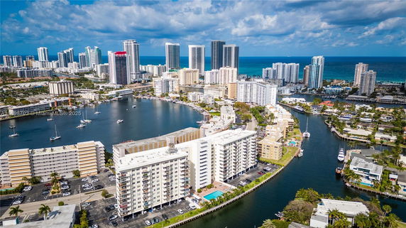 Panoramic view of coastal city with high-rise buildings and waterway.