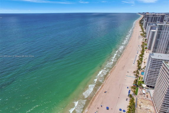 Aerial view of a coastline with buildings along the beach and ocean.