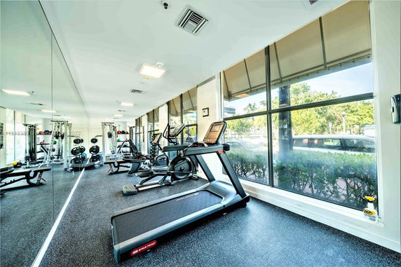 Indoor gym area with treadmills and exercise equipment.