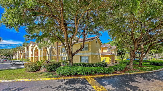 Front view of a two-story apartment building with multiple units.