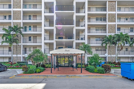 Front view of a multi-story residential building with balconies.