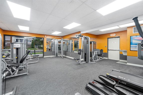 Interior view of a gym area with exercise equipment in a club house.