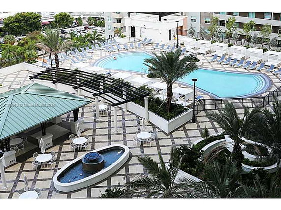 Rooftop area featuring a swimming pool, pergola, seating areas, and a water fountain.