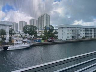 View from building overlooking a waterway with boats and surrounding buildings.