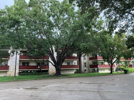 Front view of a multi-story residential building with balconies.