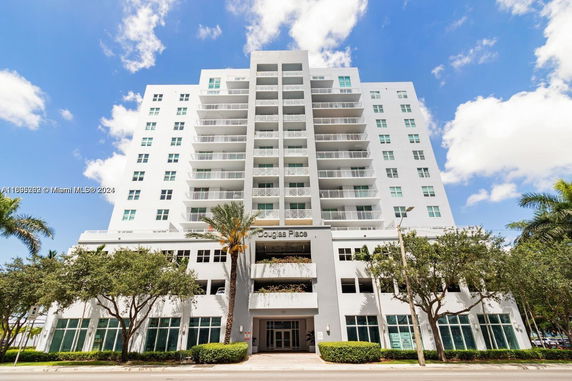 Front view of a multi-story residential building with balconies.