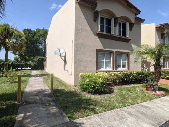 Front view of a two-story house with a satellite dish.