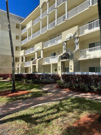 Front view of a multi-story residential building with balconies.