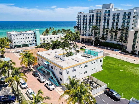 Aerial view of a coastal residential area with multiple buildings near the ocean.