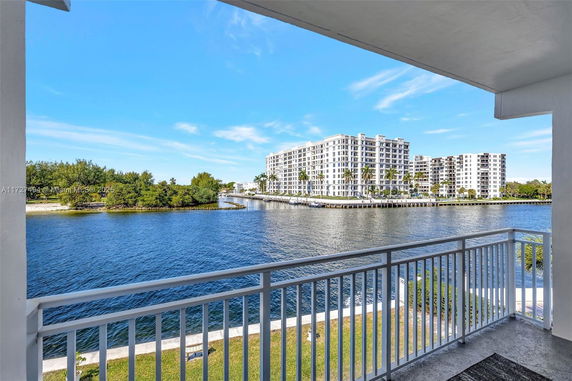 Panoramic view of waterfront with large buildings in the background.