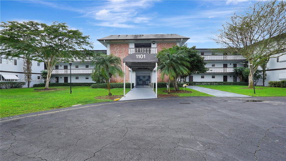 Front view of a multi-story building with a central entrance canopy.
