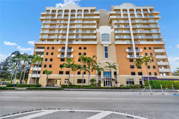 Front view of a multi-story residential building with balconies.