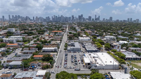 Panoramic view of a cityscape with a mix of residential and commercial buildings and a distant skyline.