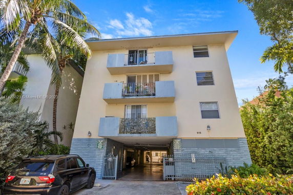 Front view of a multi-story residential building with balconies.