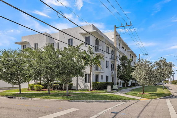 Front view of a multi-story residential building with balconies.